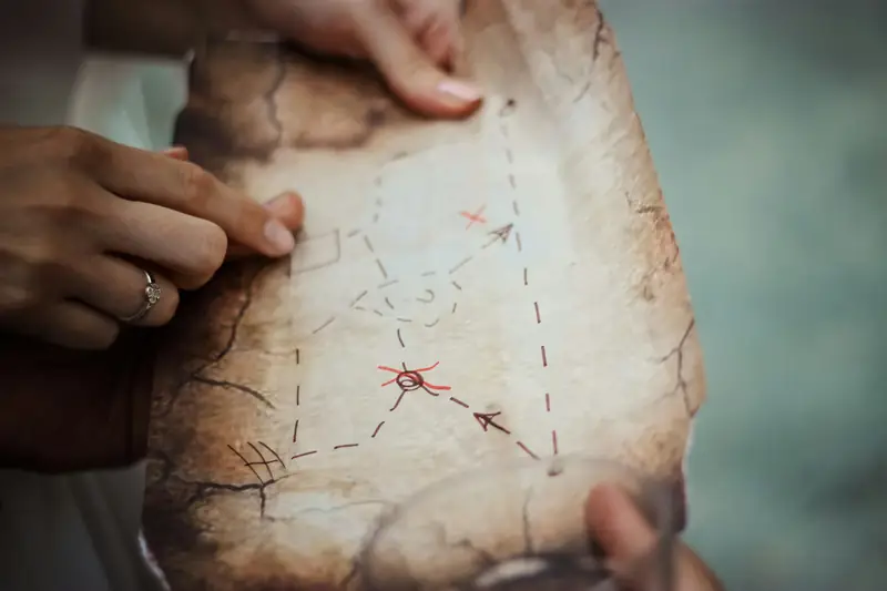 Hands holding a hand-drawn treasure map with marked route, Havelock Island