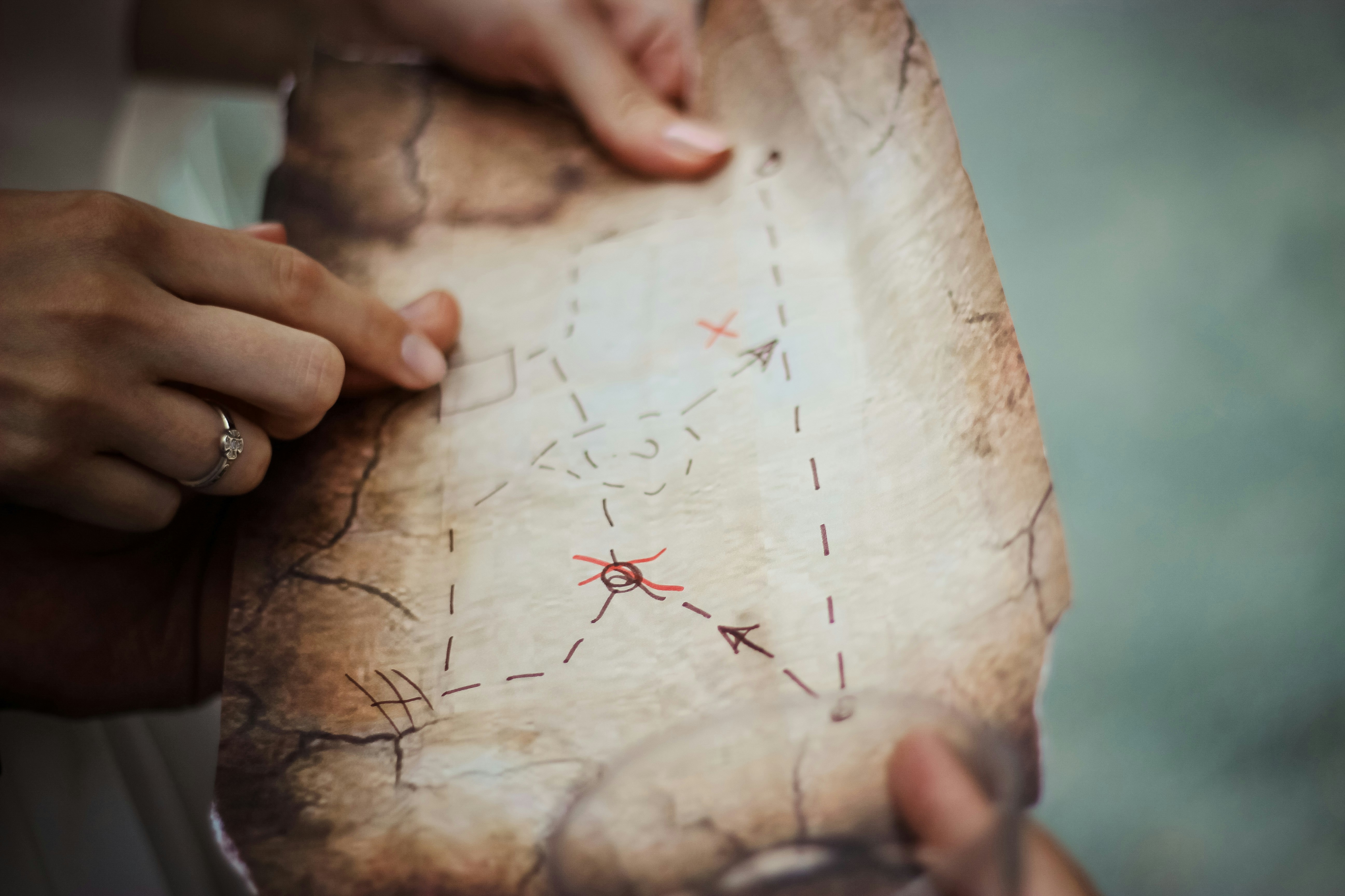 Hands holding a hand-drawn treasure map with marked route, Havelock Island
